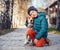 Little boy with beagle on the autumn street