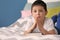 Little boy with Bible praying in bedroom