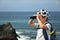 Little boy with binoculars exploring seascape