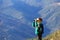 Little boy with binoculars hiking in mountains