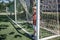 Little boy in black and orange soccer form playing football on open field in yard, young goalkeeper