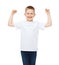 Little boy in blank white t-shirt showing muscles