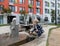 A little boy with blond hair plays with water in a modern playground. Drops of water fly around.