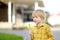 Little boy blows down dandelion fluff. Making a wish. Kids`s fun in the summer outdoors. Activity for inquisitive child