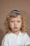 The little boy with blue eyes in Jewish knitted skullcap