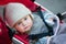 Little boy with blue eyes in a stroller