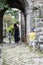 Little boy in a blue hat catches up with his mother and sister g