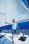 Little boy on board of sailing yacht on summer cruise. Travel adventure, yachting with child on family vacation.