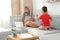 Little boy bothering mother at work in living room. Home office concept