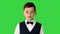 Little boy in a bow tie and waistcoat talking to the camera on a Green Screen, Chroma Key.