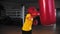 Little boy boxer walks to a punching bag and starts hitting it