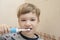 Little boy brushes his teeth with an electric toothbrush. Health care concept