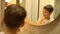 Little boy brushing his teeth in bathroom in front of mirror, oral hygiene