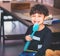 Little boy brushing teeth with giant tooth brush
