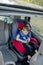 Little boy buckled up with seatbelt inside the car. Vehicle and transportation concept