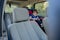 Little boy buckled up with seatbelt inside the car. Vehicle and transportation concept