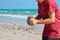 A little boy builds a sand castle. Playing with sand and toys for the ocean. A holiday with the kids at the resort.