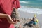 A little boy builds a sand castle. Playing with sand and toys for the ocean. A holiday with the kids at the resort.