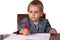 Little boy in a business suit signs documents