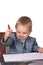 Little boy in a business suit signs documents