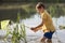 A little boy with a butterfly net catches