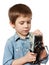 Little boy cameraman filming with retro camera