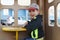 Little boy in cap plays with sand in wooden house