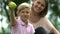 Little boy and caring mother holding apple, family stands for healthy nutrition