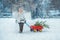 Little boy carries a Christmas tree with red wagon. the child chooses a Christmas tree.