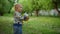 Little boy carrying ball in forest. Closeup smiling toddler boy running outdoors