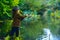 Little boy child catching a fish. Kid with fishing rod at lake. Lonely happy little boy fishing from beach lake.