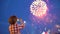 Little boy child filming pictures of beautiful fireworks in night sky display of mobile phone. Hands of baby taking