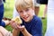 Little Boy Child Holding Baby Duckling at Petting Zoo at American Fair