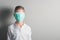 Little boy, a child in a medical mask on a bright background. The idea of an epidemic, influenza, protection from disease,