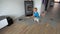 Little boy cleaning room with vacuum cleaner. Smooth camera motion