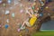 Little boy climbing a rock wall in special boots. indoor