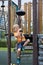 A little boy climbs a rope slide on the playground. He`s satisfied. Concept of childhood, games