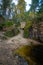 The little boy climbs the steep trail to the top. There is a small lake below