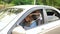 A little boy closes his mother`s eyes while driving a car. Child indulges in car