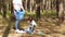 A little boy collects garbage in the woods and puts it in a bag with his mother. Family activists cares about nature