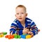 Little boy with color toys on white