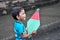 A little boy with a colorful kite in hand.