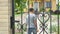 Little boy coming home, opening, closing gate, yard, summer