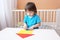 Little boy constructing house of paper details