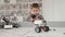 Little boy controls a robot using his phone in a robotics class