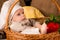 Little boy in the cook costume in a basket