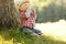 Little boy in a cowboy hat playing on nature