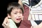 Little boy crying holding his mother black background