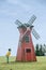 Little boy curiously looking at a windmill