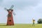 Little boy curiously looking at a windmill